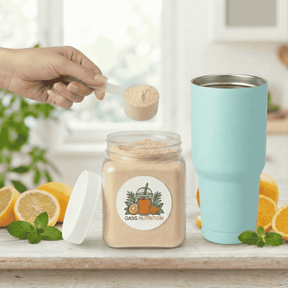 Person scooping powder from a jar labeled 'Oasis Nutrition' with a turquoise tumbler and lemons in the background.